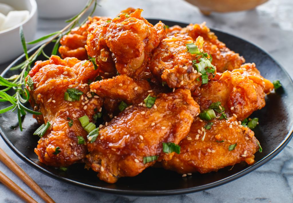 Chicken wings on a plate with with sriracha
